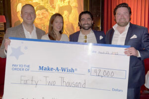 Ryan Chismark with check for the Make a Wish foundation